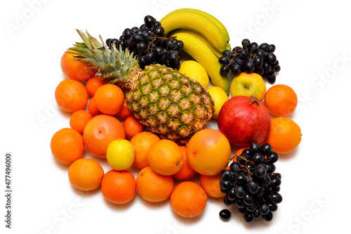 heap of different types of citrus and tropical fruits close-up on a white background