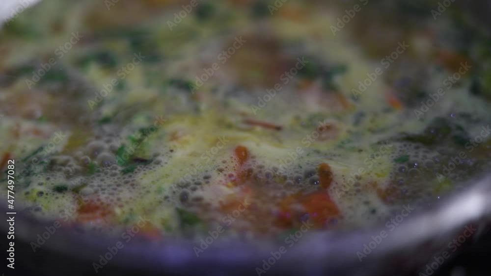 Upma boiling in steel vessel. Indian dish cooking with vegetables Upma boiling in steel vessel. Indian dish cooking with vegetables