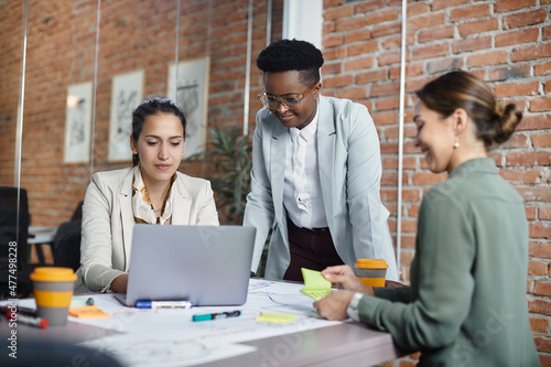 Team of multiracial businesswomen working during a meting at corporate office. photo