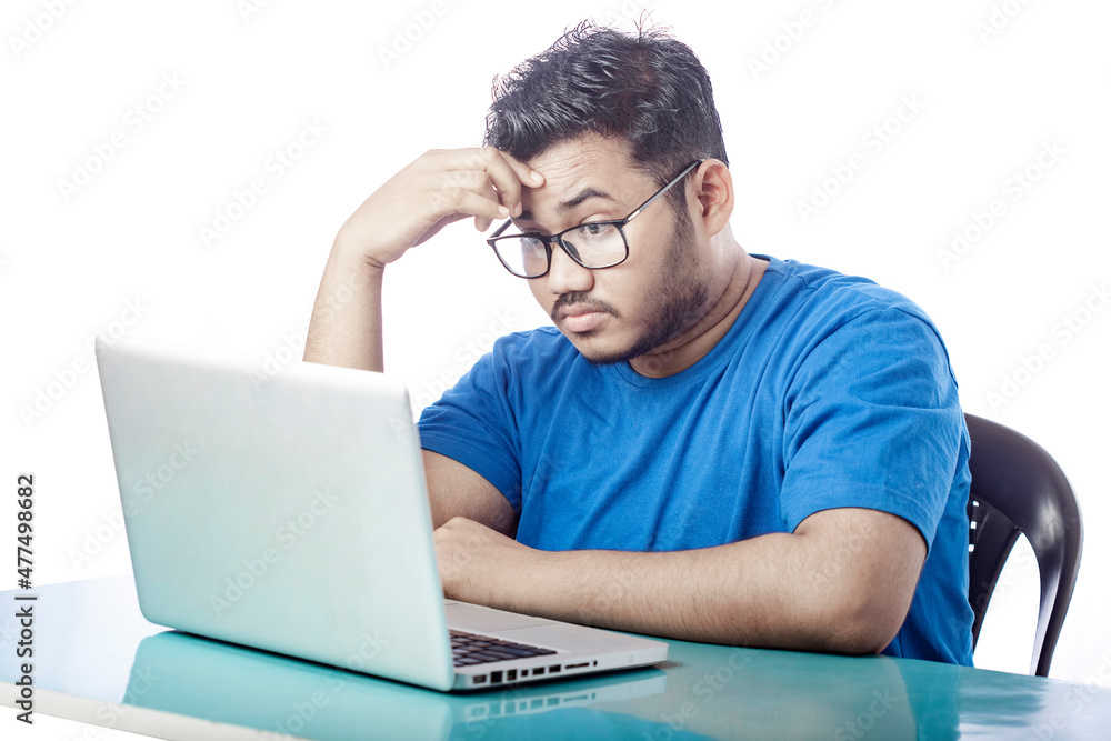 casual dressed boy stressed expression in front of a laptop casual dressed boy stressed expression in front of a laptop