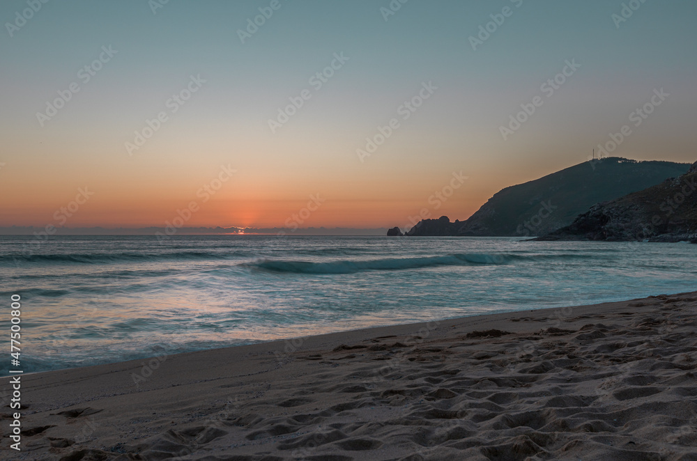 Last view of the sun at Finisterre Beach, endpoint of the Camino de Santiago Last view of the sun at Finisterre Beach, endpoint of the Camino de Santiago