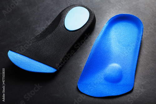 Orthopedic insoles for correction of pronation of the foot on a dark background.