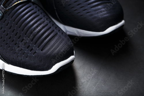 Black and white ultra-modern sports sneakers on a black background. photo