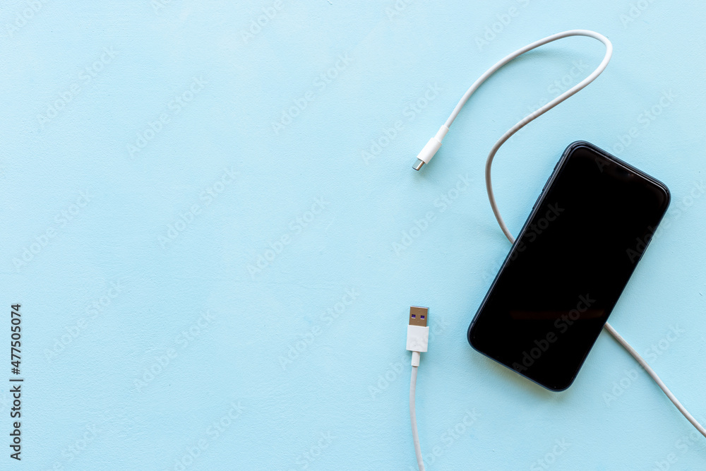 Obraz premium Usb cable for charging smartphone or laptop, top view
