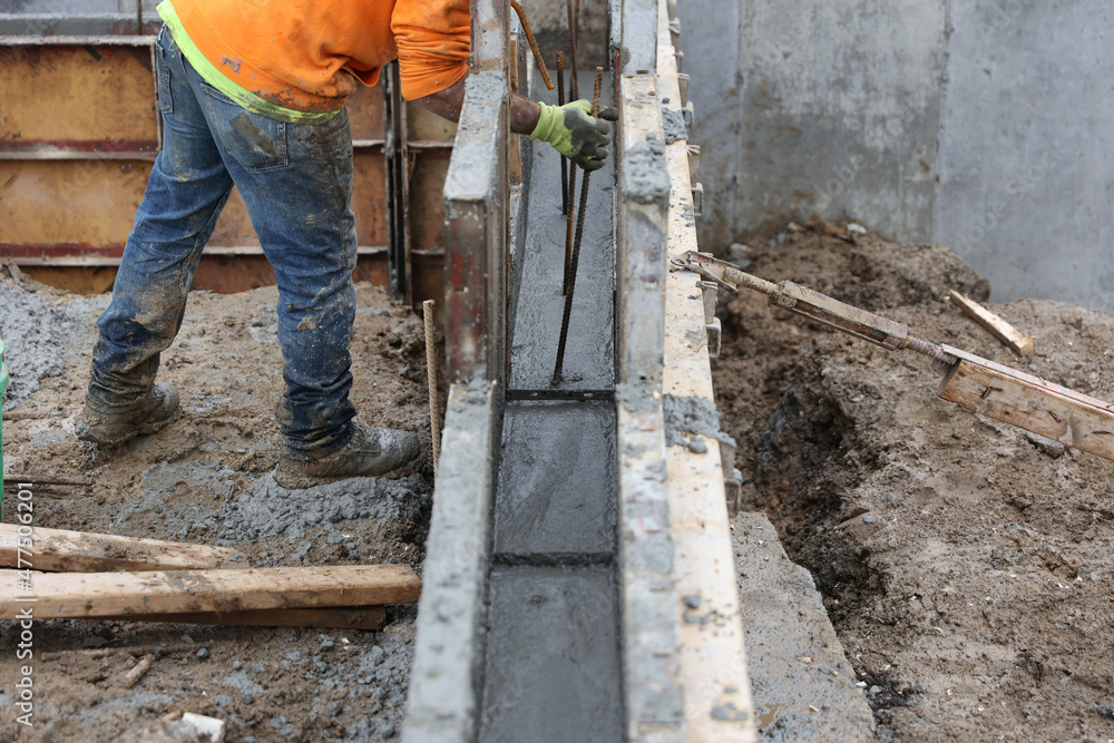 Rebar is placed in newly poured concrete. Stock Photo Adobe Stock
