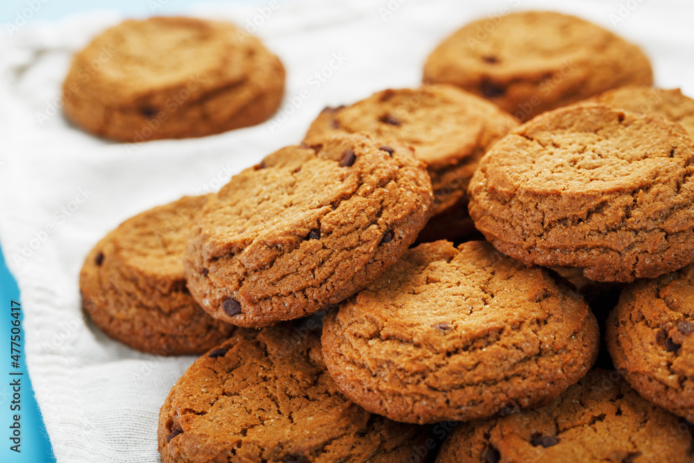 Oatmeal cookies on a napkin on a blue background Oatmeal cookies on a napkin on a blue background