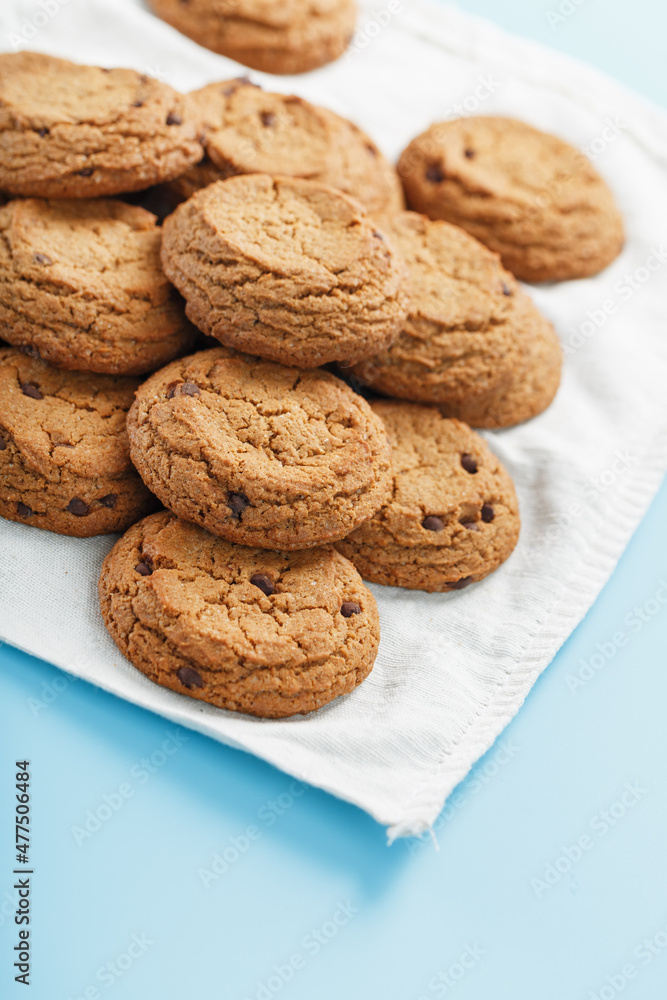Oatmeal cookies on a blue background and a white napkin top view Oatmeal cookies on a blue background and a white napkin top view