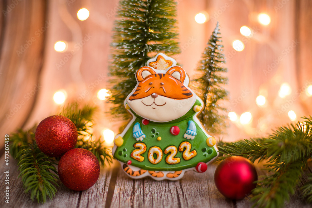 Tiger is the symbol of the year 2022. A tiger in the form of a gingerbread with number 2022. Symbol of the year. Beautiful tiger on a wooden background. Christmas composition with a homemade tiger. Tiger is the symbol of the year 2022. A tiger in the form of a gingerbread with number 2022. Symbol of the year. Beautiful tiger on a wooden background. Christmas composition with a homemade tiger.