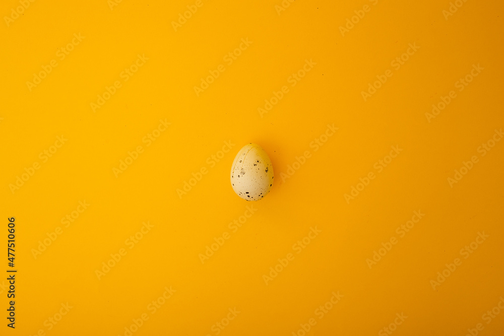 Small quail eggs lie on a yellow background, minimalism for advertising