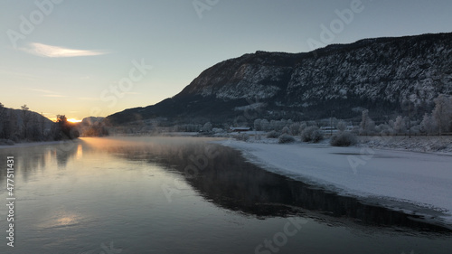 Sunrise over the river Hallingdalselva. Shot at Nesbyen  Norway. It is December and minus 20 degree outside. The water in the river is warmer than the air so therefor the smoke on the river. Frost. 