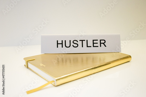 hustler desk sign on gold 