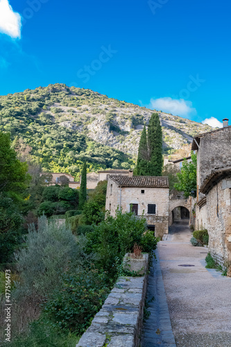 Saint-Guilhem-le-Desert in France, view of the village, typical street and houses

