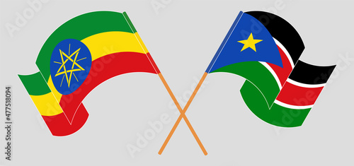 Crossed and waving flags of Ethiopia and South Sudan