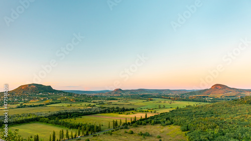 Breathtaking sunset view of a group of hills and fields around Szigliget.