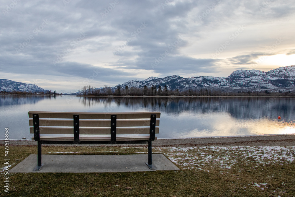 An empty park bench on a cold December day at Osoyoos Lake in BC, Canada