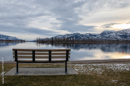 An empty park bench on a cold December day at Osoyoos Lake in BC, Canada