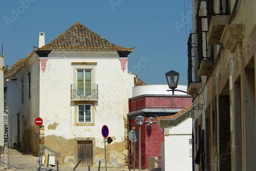 An empty street with deteriorated residential buildings in Tavira