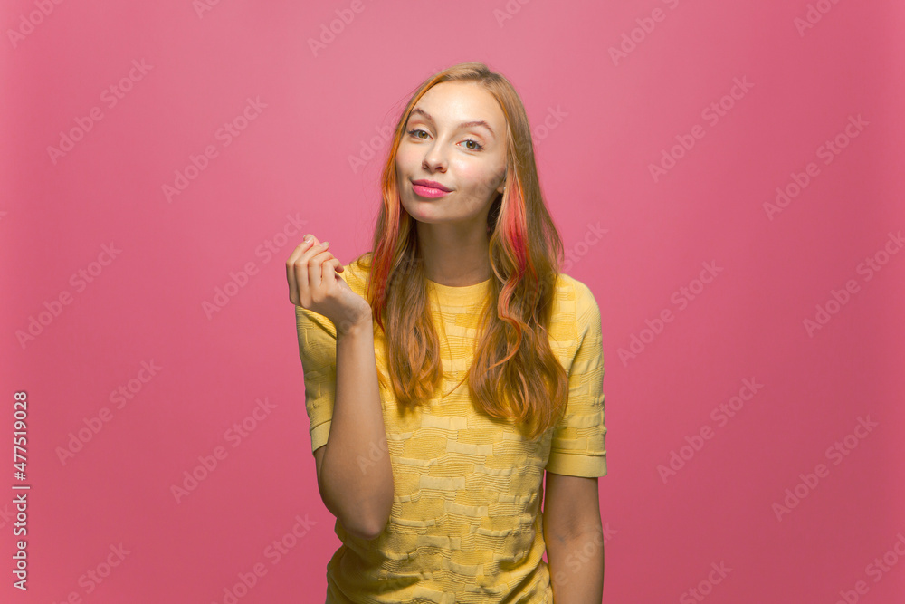 Money gesture. Confident selfish young beautiful girl asking payment, financial reward, debt on pink studio background Money gesture. Confident selfish young beautiful girl asking payment, financial reward, debt on pink studio background