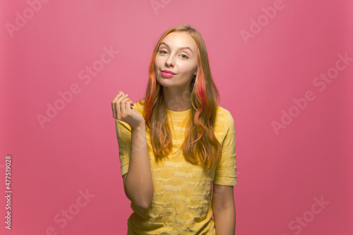 Money gesture. Confident selfish young beautiful girl asking payment  financial reward  debt on pink studio background