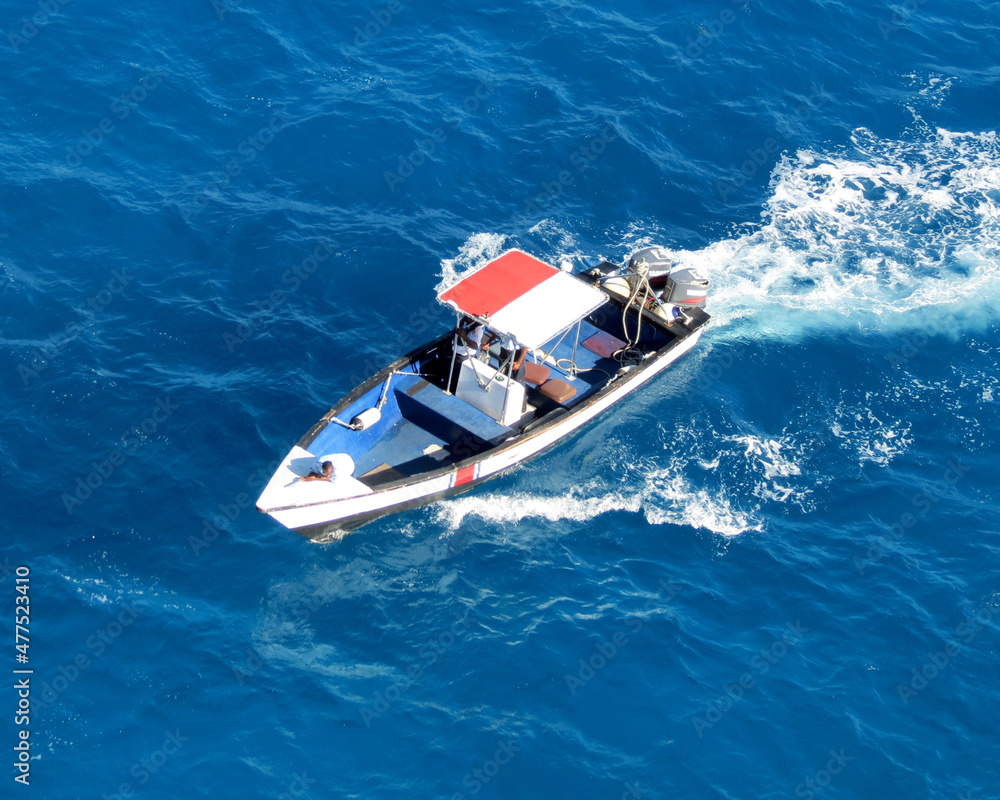Motorboat in turquese waters of Sint Maarten harbor
