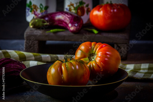 Preparation with vegetables on dark ground in the kitchen