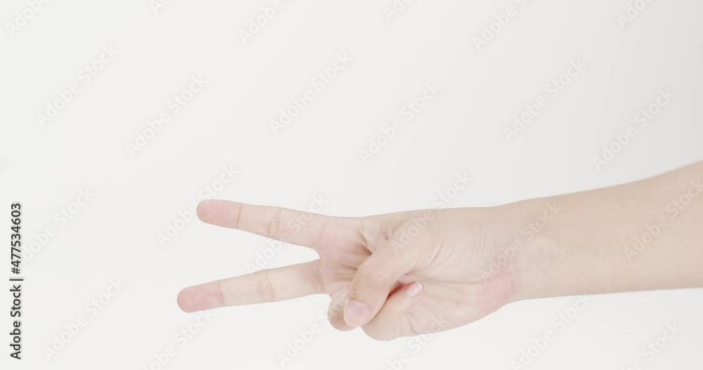Raise your hand with two fingers and hold it. For success and encouragement. On the white background. Raise your hand with two fingers and hold it. For success and encouragement. On the white background.