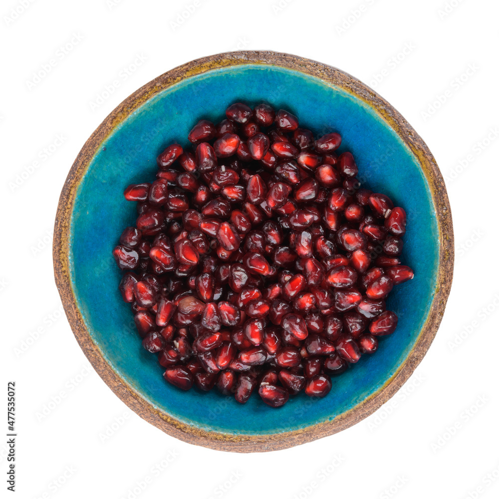 Pommegranate seed on blue ceramic bowl Pommegranate seed on blue ceramic bowl