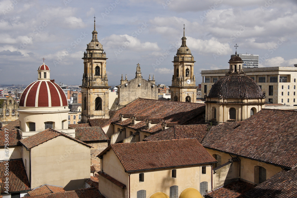 Rooftops, domes, and towers of historic buildings in La Candelaria district of Bogota, Colombia, with La Catedral Primada and Capilla Sagrario in foreground