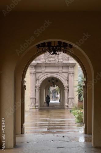 Alone person walking thru at El Prado colonnade on a rainy day