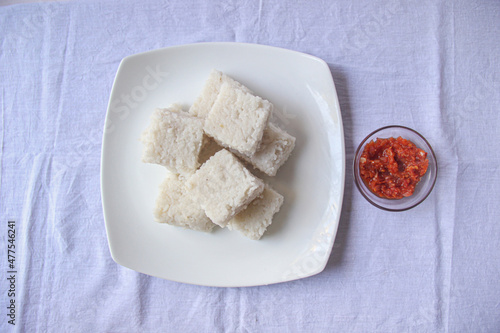 Top shot of a kiribath and a lunu miris plate on the white background for new year season. aurudu traditional food 
