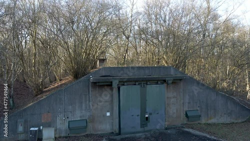 Jib up of old ammunition bunker hidden in a forest photo