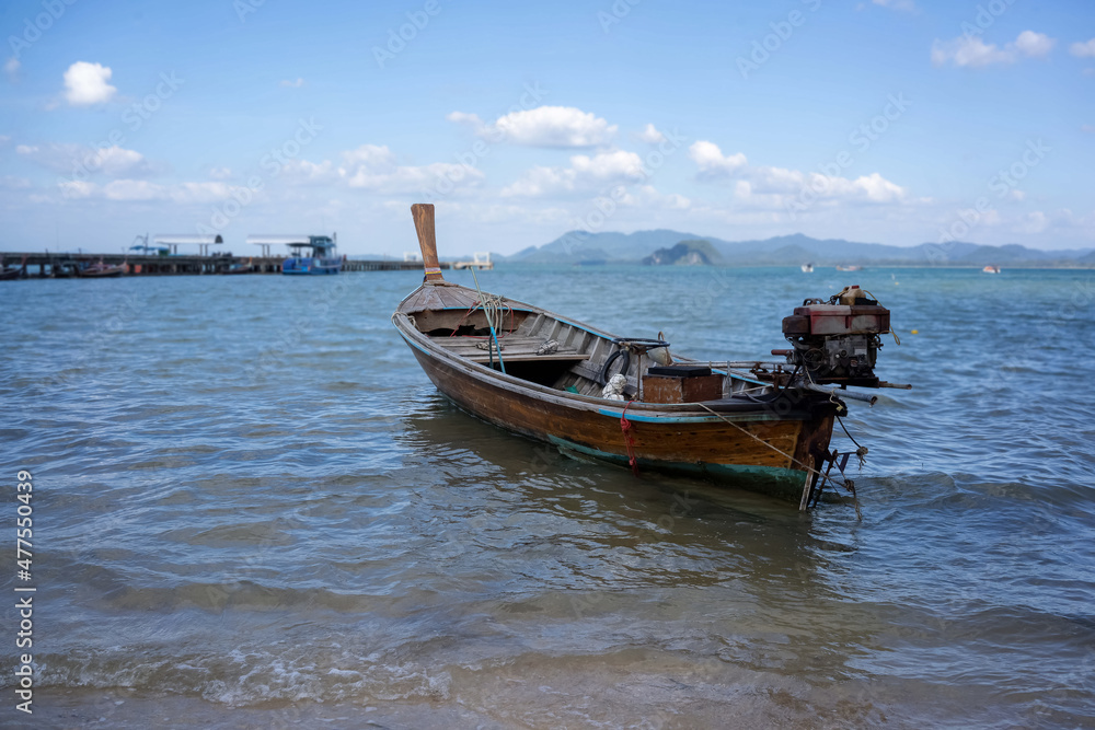 The wooden boat in the day time. Very nice view at the beautiful beach of Thailand.