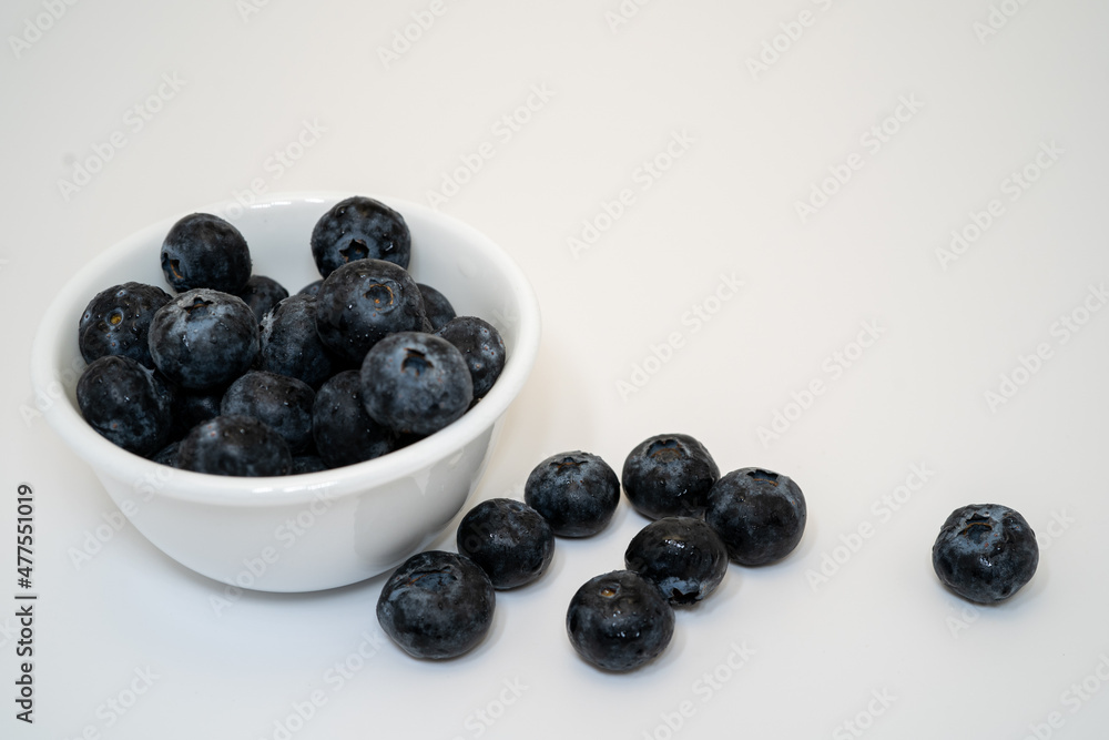 blueberries in a bowl with white smooth background, blank space for writing blueberries in a bowl with white smooth background, blank space for writing