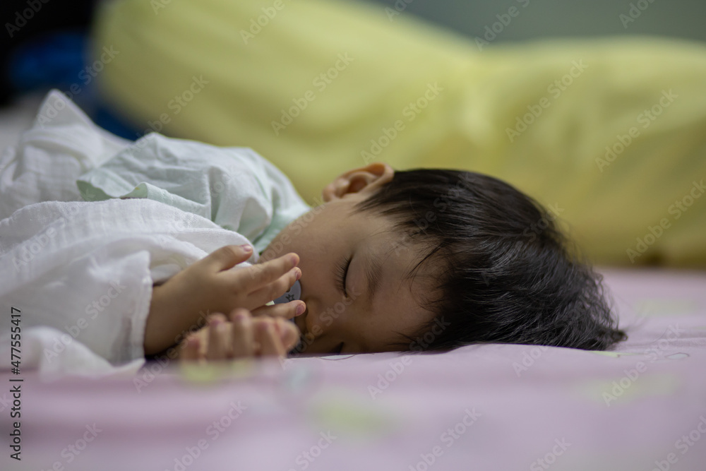 Close-up Adorable cute toddler or baby sleeping on bed Close-up Adorable cute toddler or baby sleeping on bed