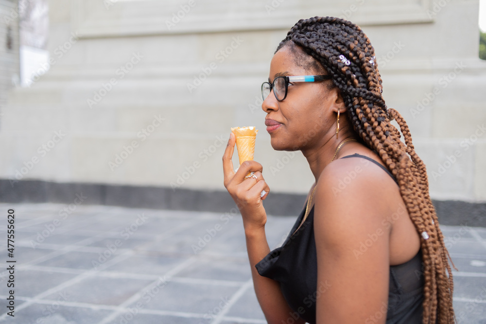 Tourist in black blouse eating ice cream on some stairs Tourist in black blouse eating ice cream on some stairs