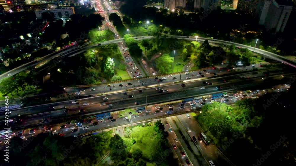 Aerial view on highways and skyscrapers. Spectacular nighttime skyline of a big modern city at night. With noise cloud. JAKARTA - Indonesia Aerial view on highways and skyscrapers. Spectacular nighttime skyline of a big modern city at night. With noise cloud. JAKARTA - Indonesia