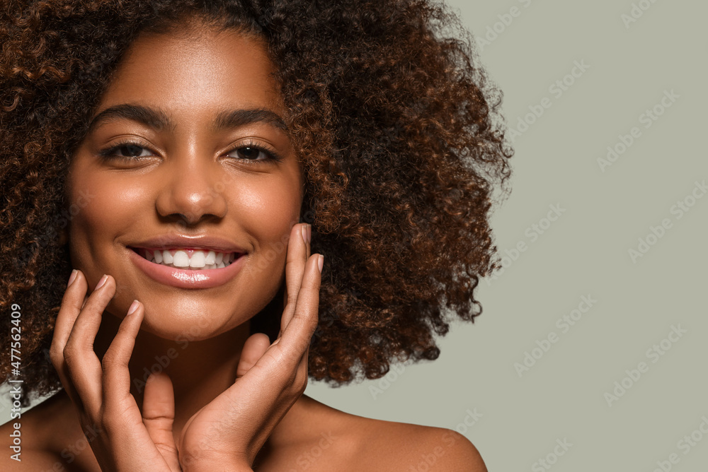 Beautiful african woman black t-shirt portrait afro haircut touching her face Color background green Beautiful african woman black t-shirt portrait afro haircut touching her face Color background green