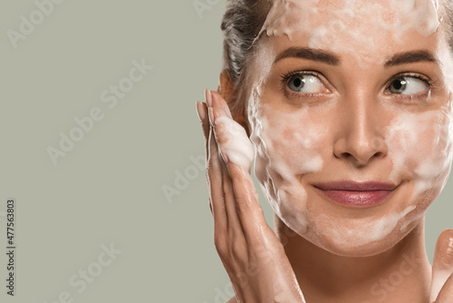 Soap face woman clean skin beauty. Color background. Green photo