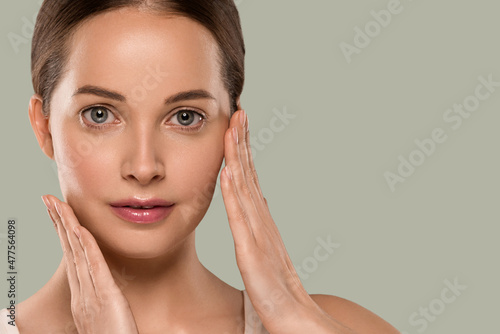 Beauty healthy skin woman touching her face beautiful female. Color background. Green