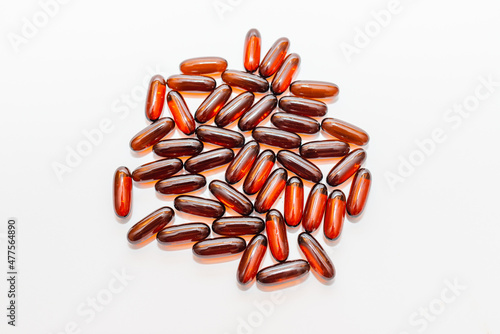 Oil brown pills D3 on the white background. Flat lay capsules vitamin D closeup,selective focus.Copy space.