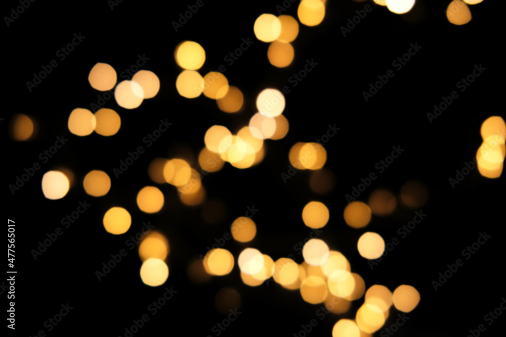 Blurred golden festive lights. Blurred backdrop for holidays and parties. Christmas Party concept