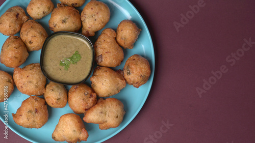 Delicious Indian snacks Punugulu served in a plate with Tomato and green Chutney photo