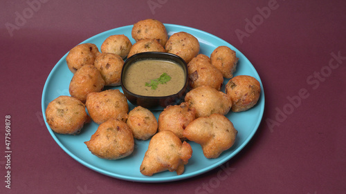 Delicious Indian snacks Punugulu served in a plate with Tomato and green Chutney photo