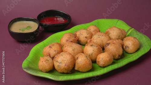 Delicious Indian snacks Punugulu served in a plate with Tomato and green Chutney