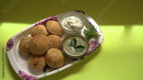 Appum or Appe, Appam or Mixed dal or Rava Appe served with green   chutney. A Ball shape popular south Indian breakfast dish, Selective focus
 photo