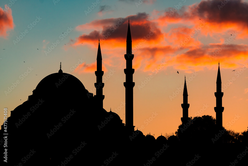 Islamic background photo. Silhouette of Suleymaniye Mosque at sunset with clouds