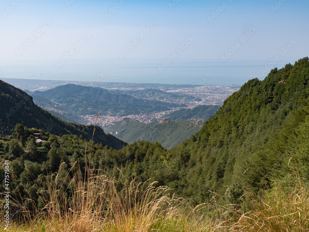 View of the marble Quarries of Carrara, the paths carved into the side of the mountain and the town of Carrara and the Coast in front of it View of the marble Quarries of Carrara, the paths carved into the side of the mountain and the town of Carrara and the Coast in front of it