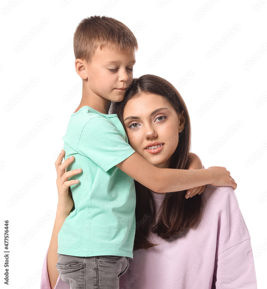 Little boy and his older sister hugging on white background Little boy and his older sister hugging on white background