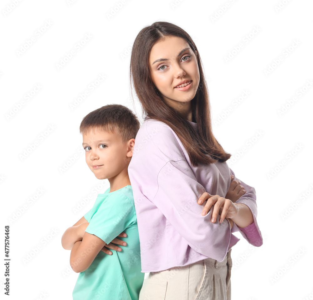 Little boy with his older sister on white background Little boy with his older sister on white background