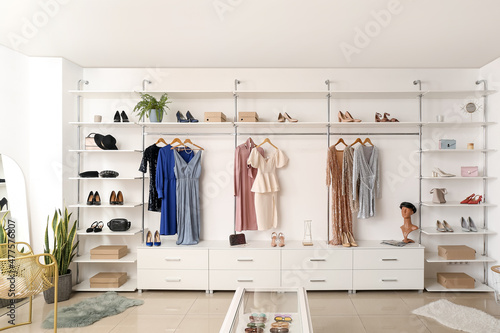 Interior of boutique with trendy clothes, shoes and accessories Fototapet